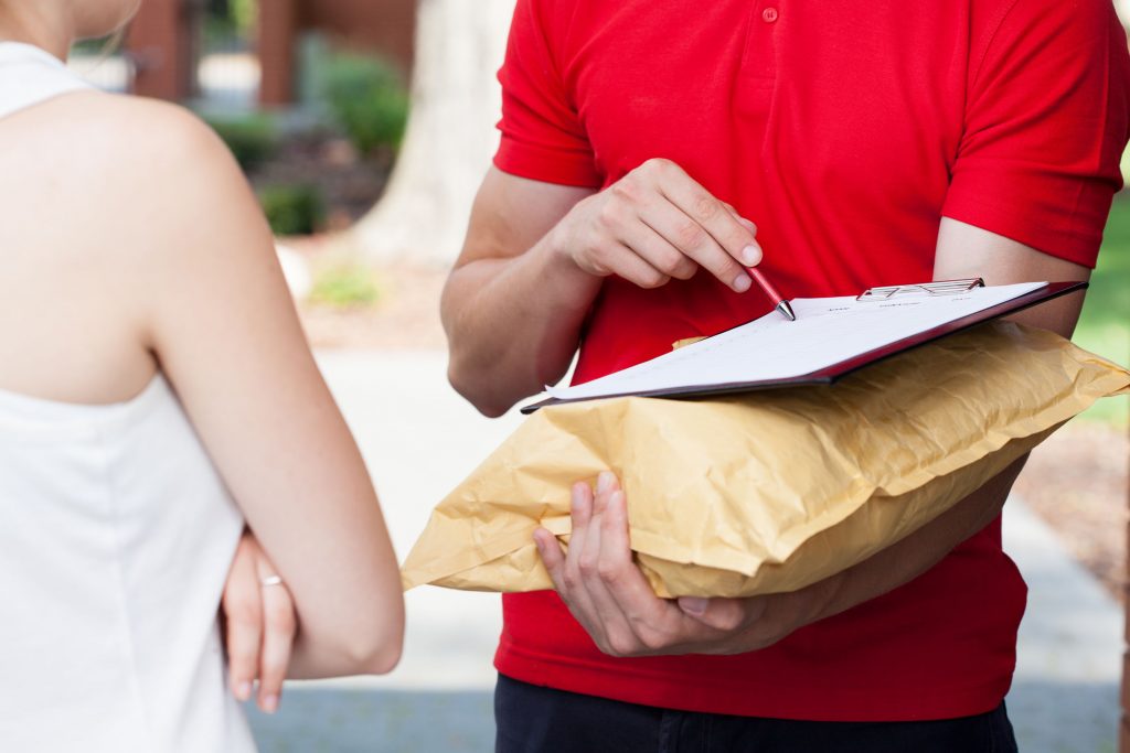 Close-up of a delivery man asking for a signature