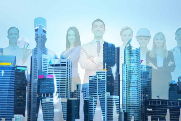 people, profession, qualification, employment and success concept - happy businessman over group of professional workers over city background